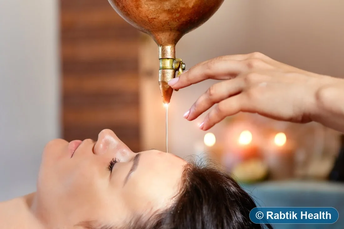 Illustrative traditional Shirodhara oil application